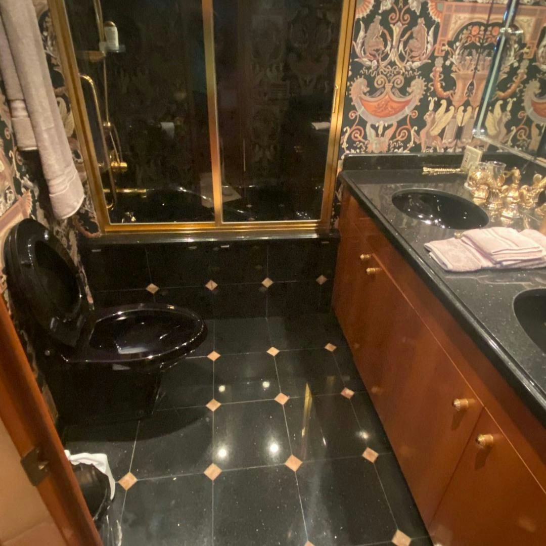 a black tiled bathroom aboard SOCIAL DIRECTOR Yacht for Sale