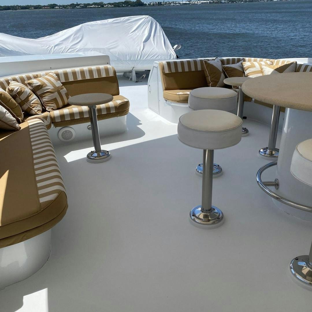 a group of stools on a white surface by a body of water aboard SOCIAL DIRECTOR Yacht for Sale