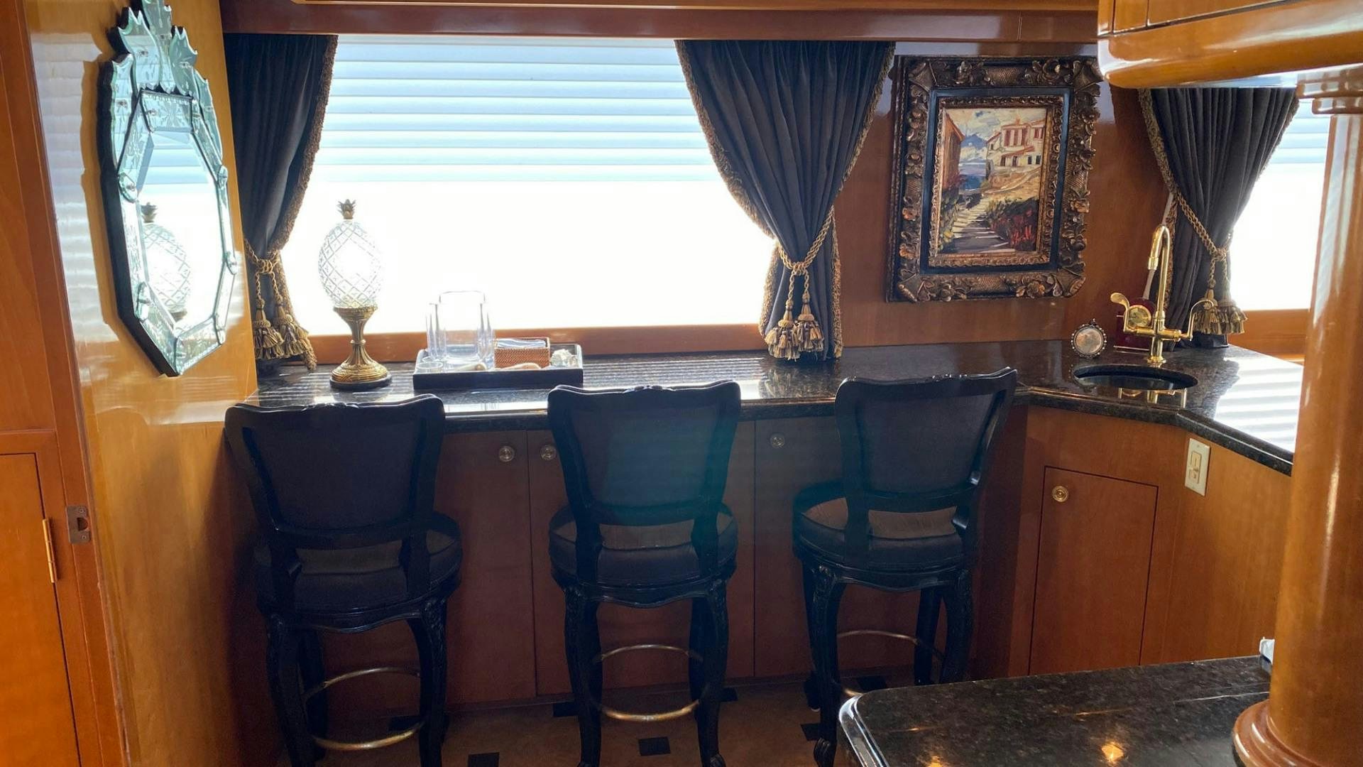 a kitchen with a table and chairs aboard SOCIAL DIRECTOR Yacht for Sale
