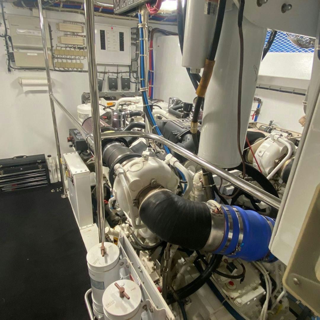 a person in a blue glove working on a machine aboard SOCIAL DIRECTOR Yacht for Sale