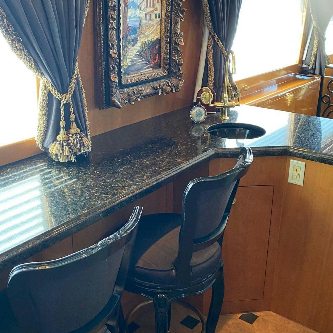 a table with a chair and a lamp on it aboard SOCIAL DIRECTOR Yacht for Sale