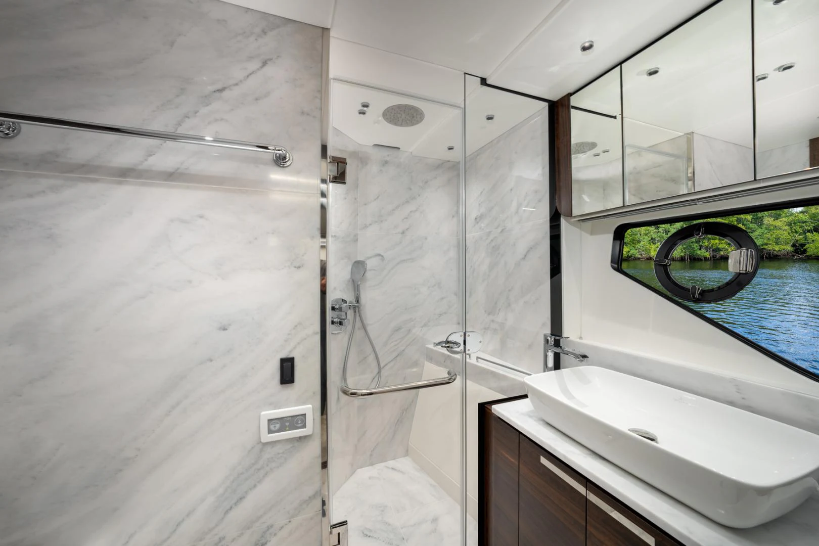 a bathroom with a sink and a mirror aboard DEALER DEMO Yacht for Sale