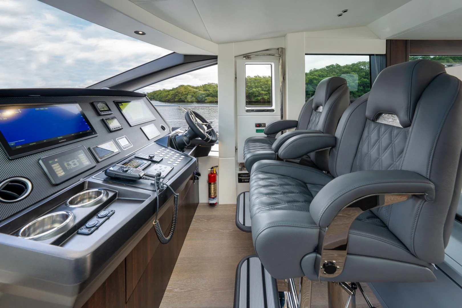 inside of a vehicle with a desk and chairs and a computer on the table aboard DEALER DEMO Yacht for Sale
