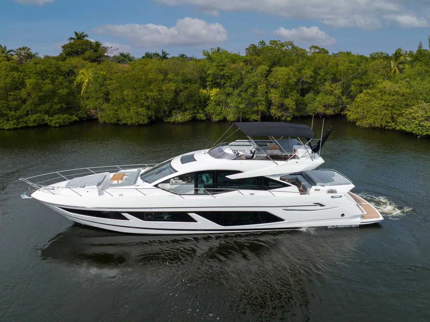a white boat on the water aboard DEALER DEMO Yacht for Sale