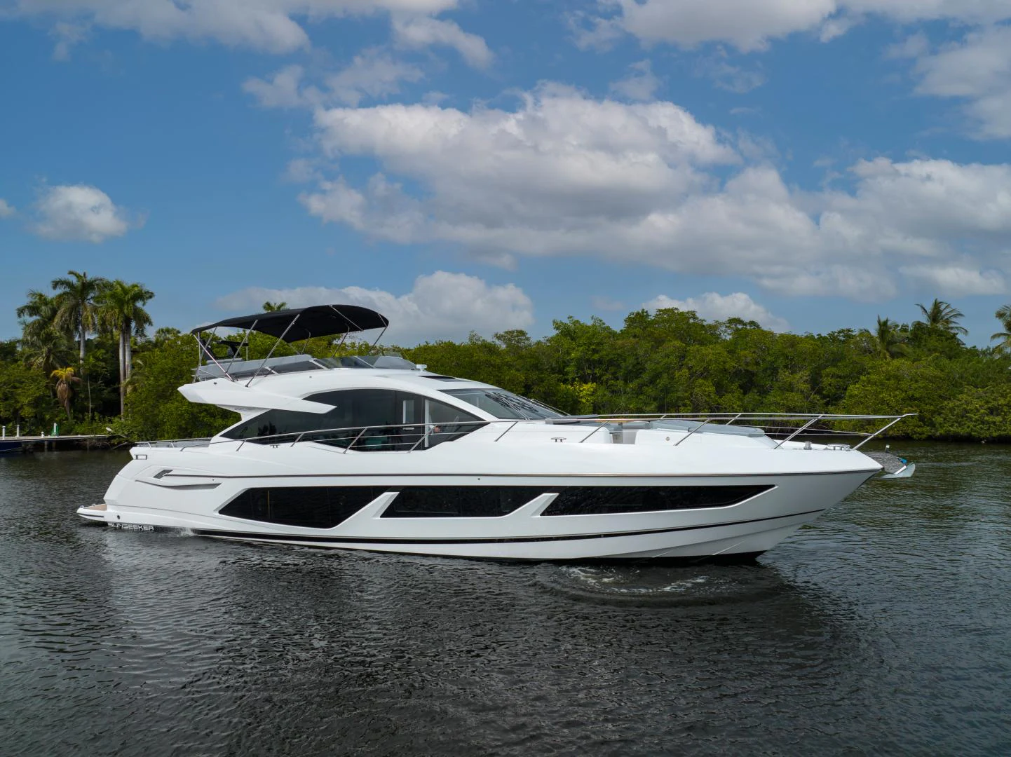 a white boat on the water aboard DEALER DEMO Yacht for Sale