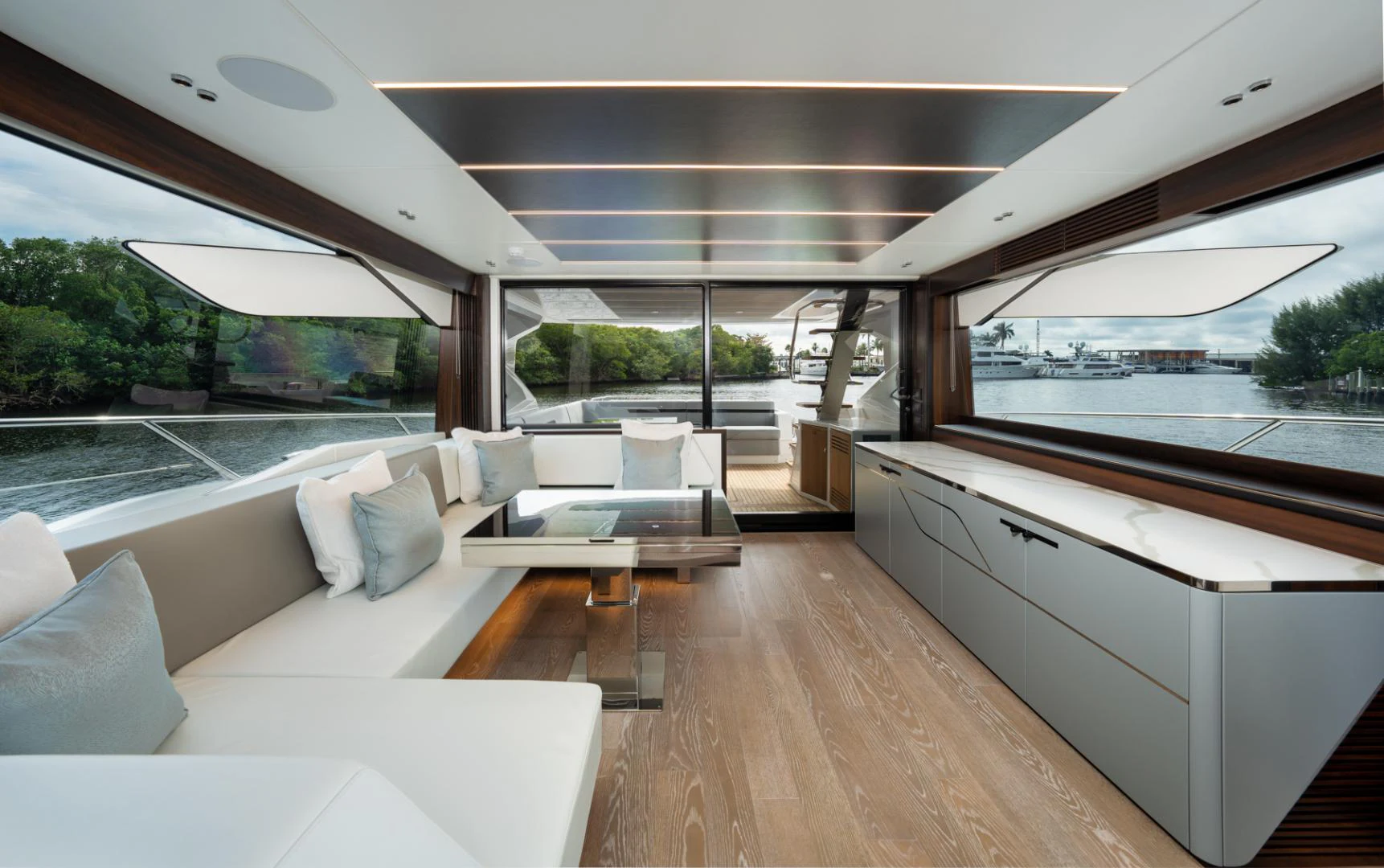 a room with a couch and a table and a large window aboard DEALER DEMO Yacht for Sale