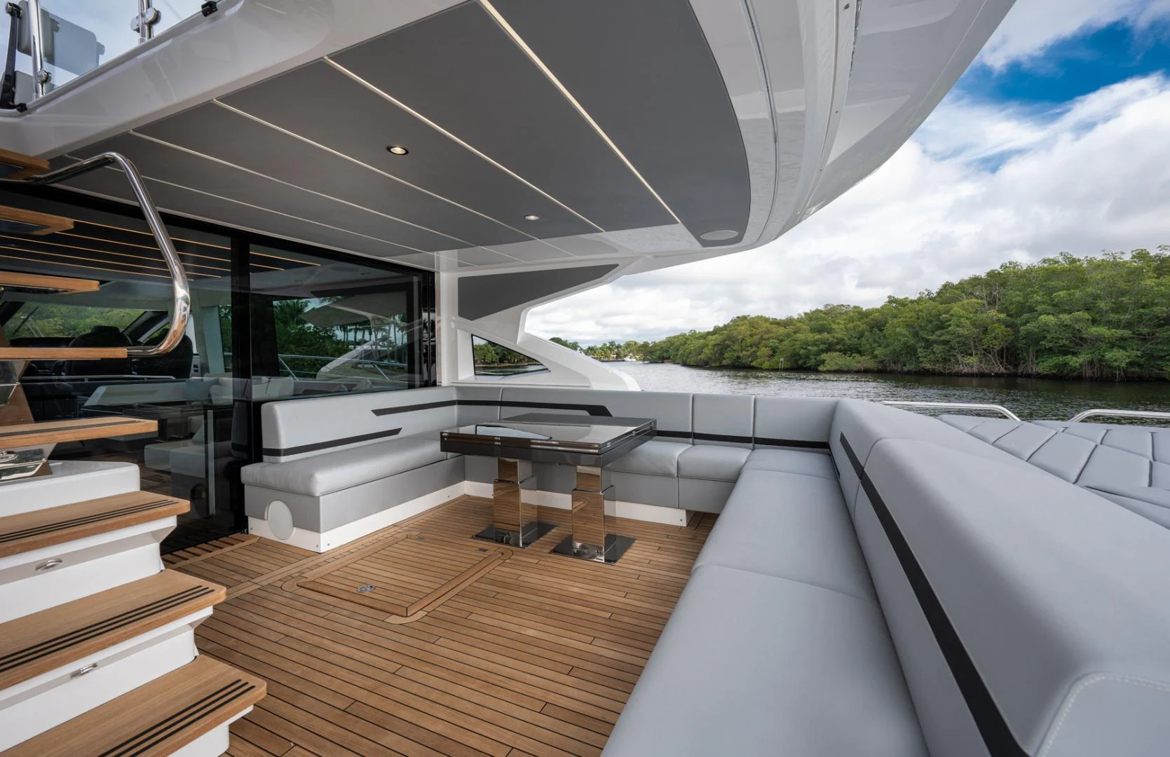 a room with a wood floor and a table and a bench aboard DEALER DEMO Yacht for Sale