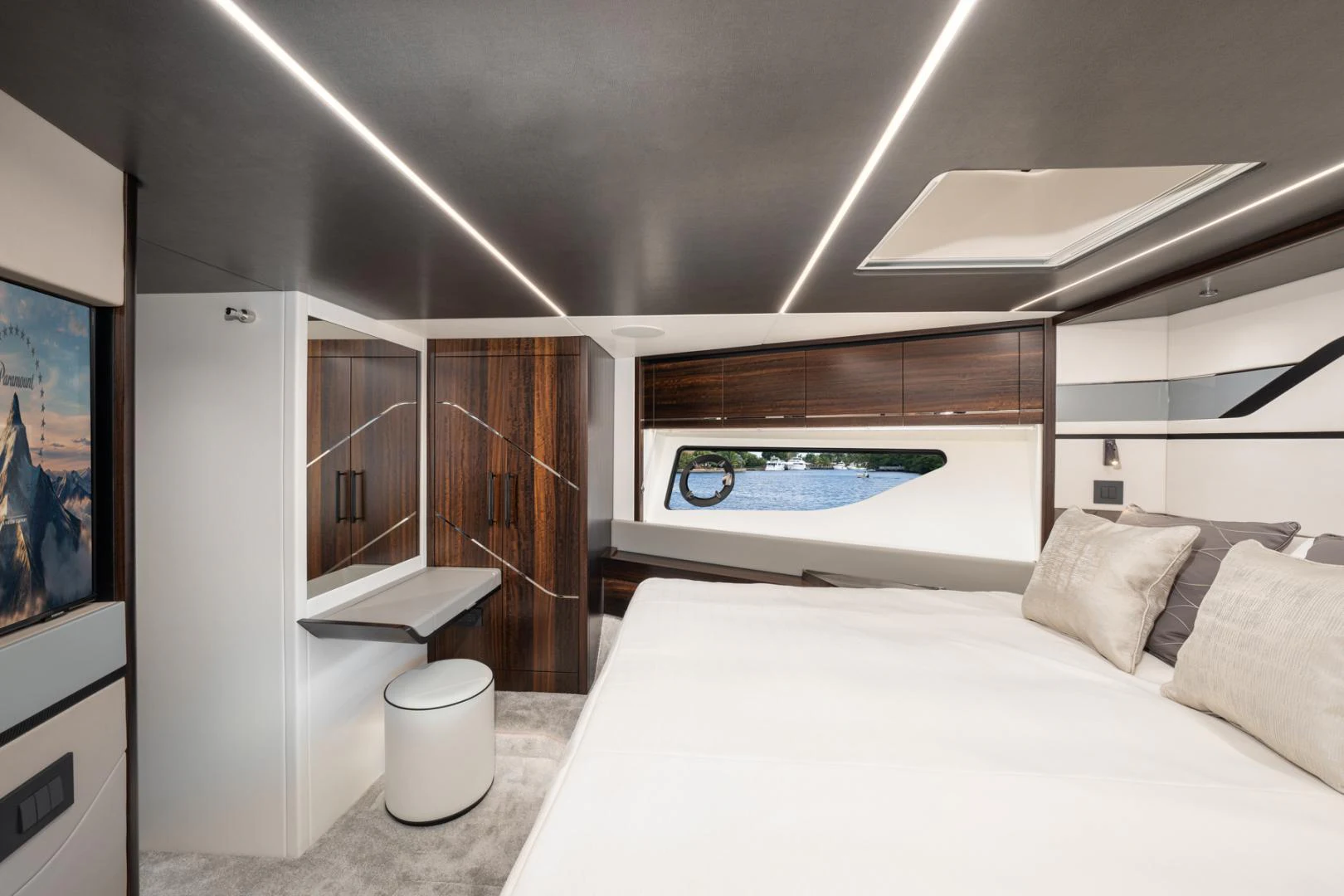 a room with a bed and a television aboard DEALER DEMO Yacht for Sale
