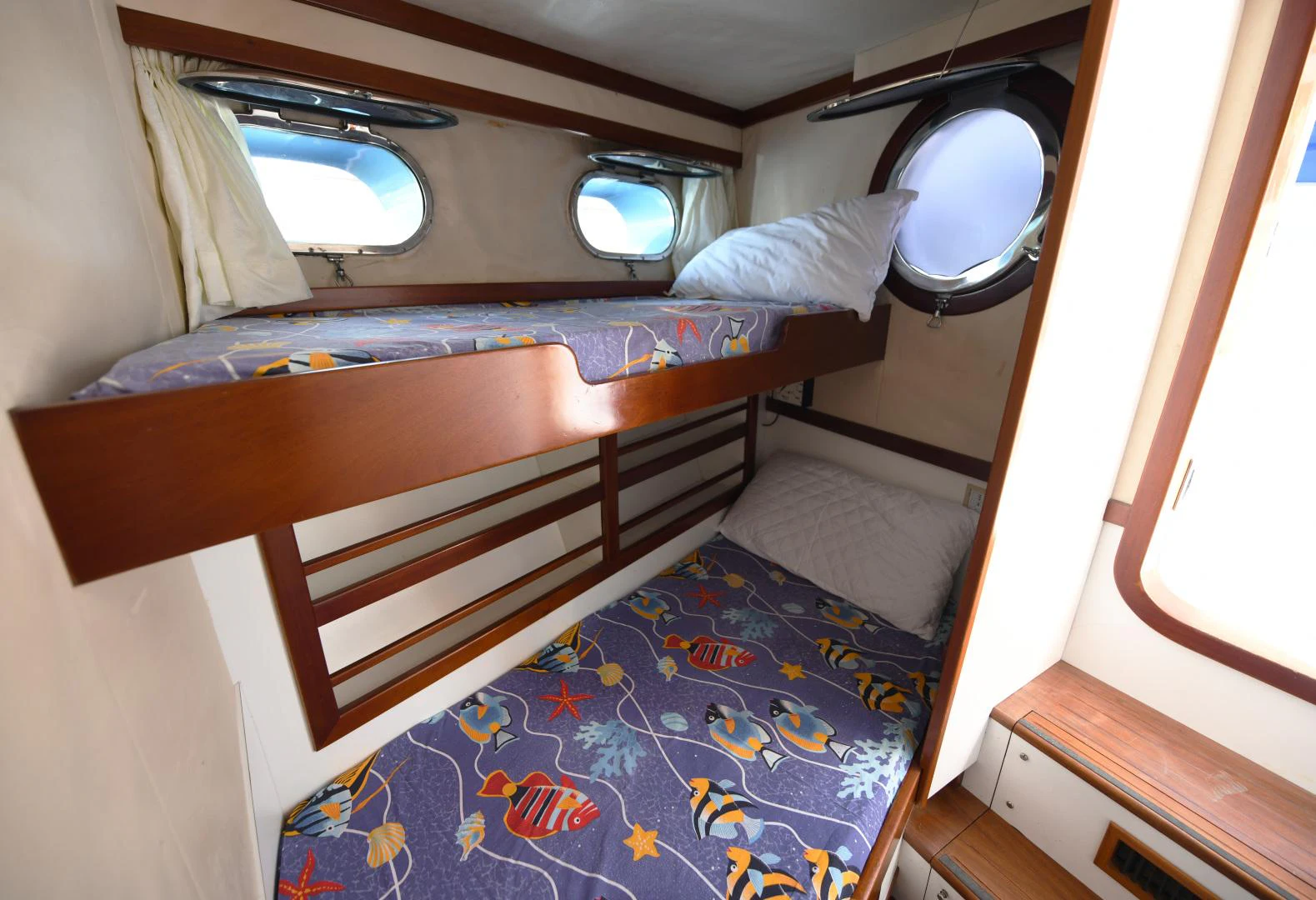 a bed with a blue sheet aboard AMARELLA F Yacht for Sale