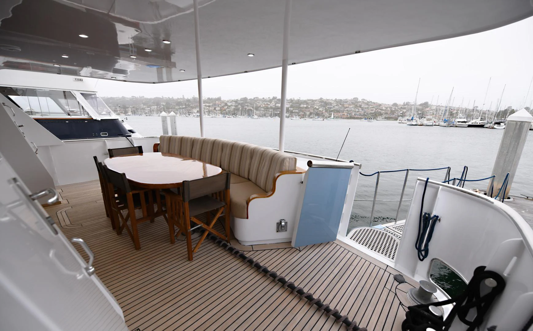 a deck with a table and chairs on it aboard AMARELLA F Yacht for Sale