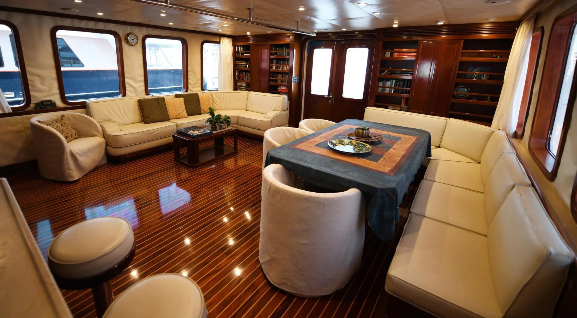 a living room with a table and chairs aboard AMARELLA F Yacht for Sale