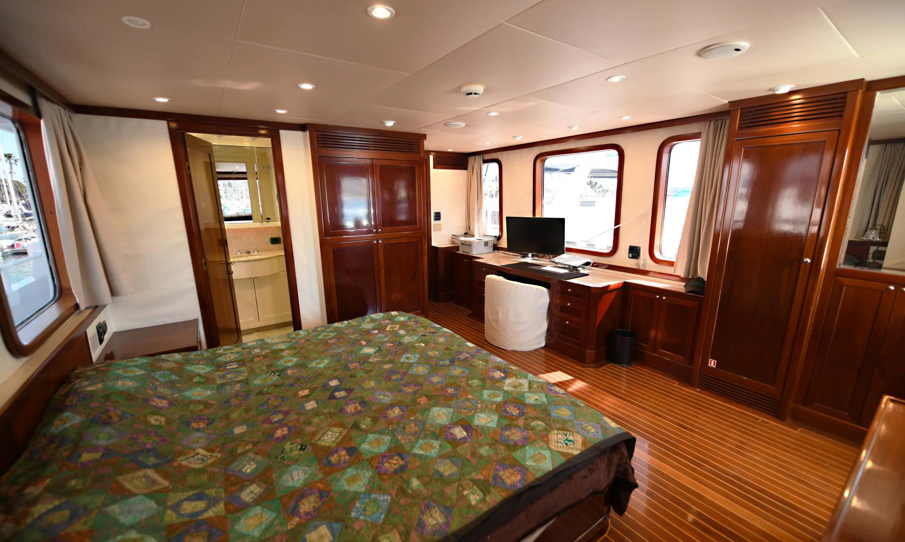 a bedroom with a bed and desk aboard AMARELLA F Yacht for Sale