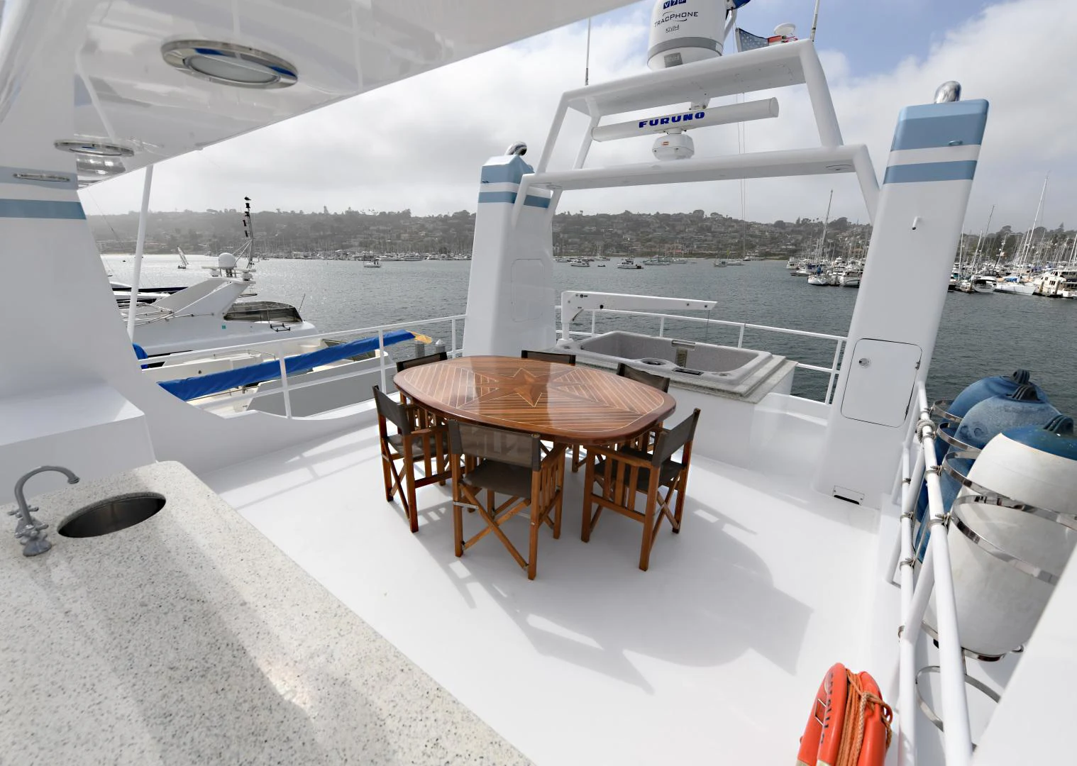 a table and chairs on a boat aboard AMARELLA F Yacht for Sale