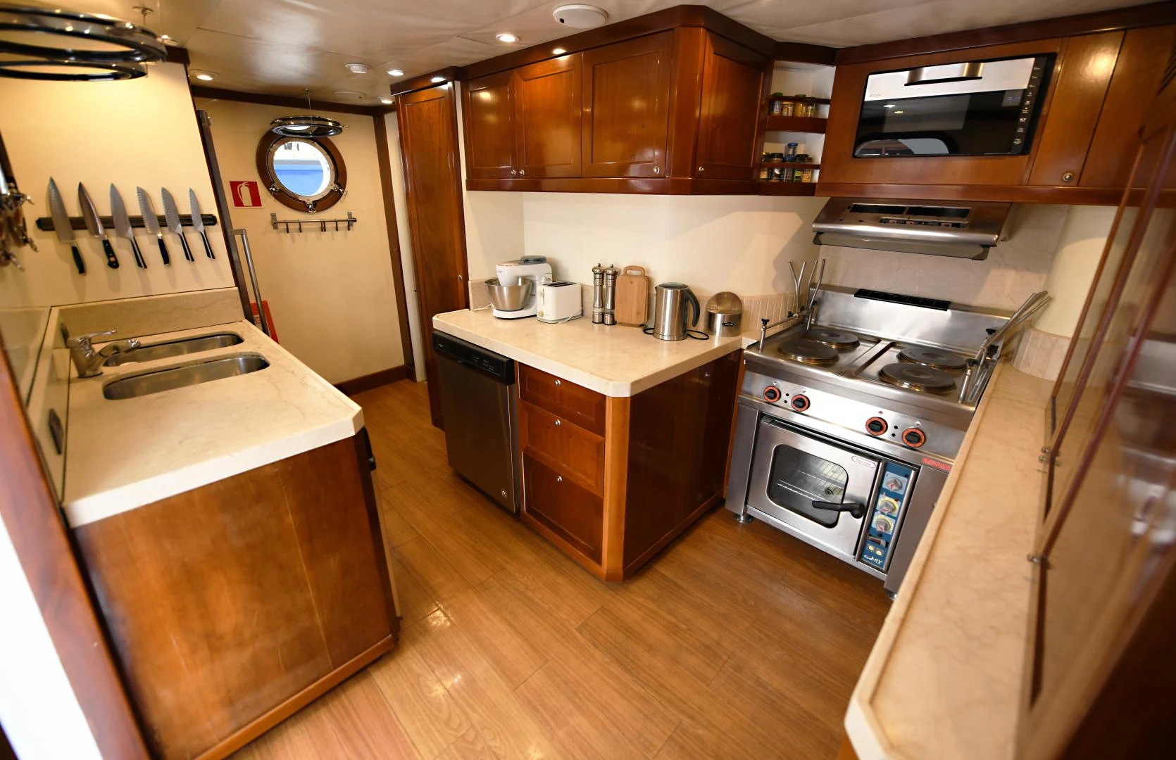 a kitchen with wooden cabinets aboard AMARELLA F Yacht for Sale