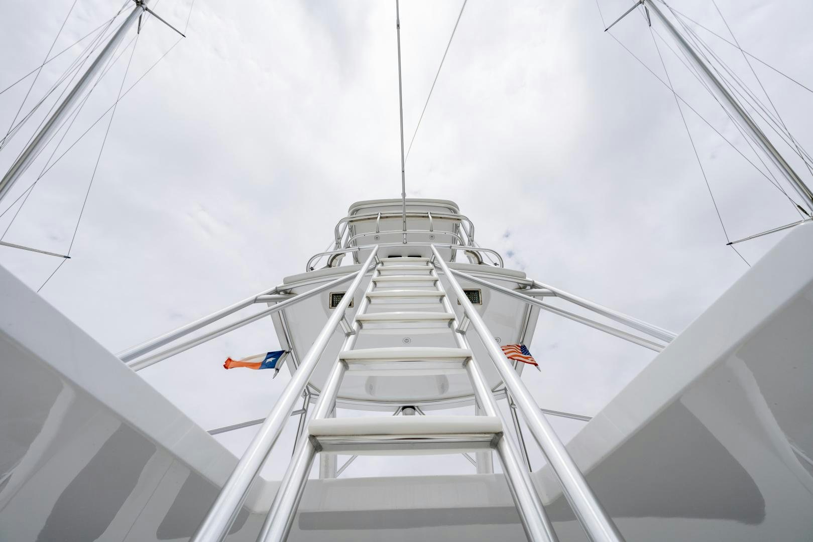a group of people on a tall white tower with flags aboard MM CRICKET Yacht for Sale
