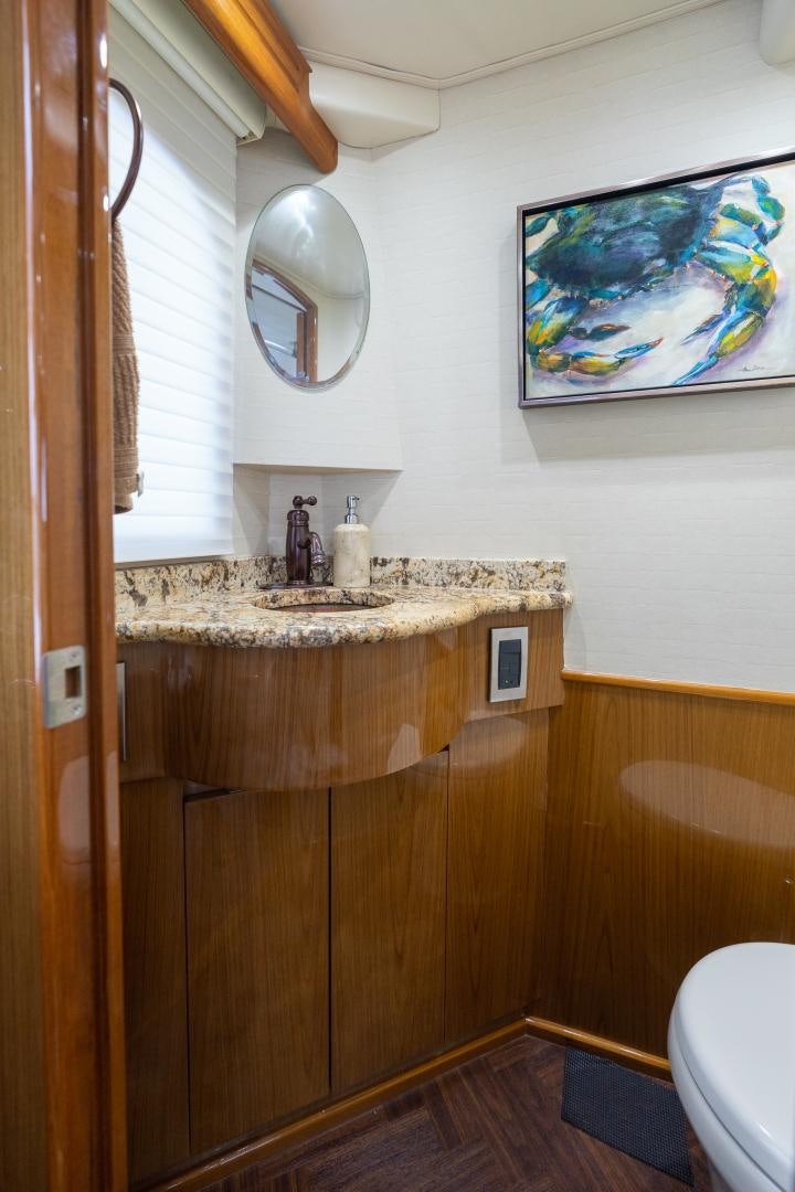 a bathroom with a sink and a mirror aboard MM CRICKET Yacht for Sale