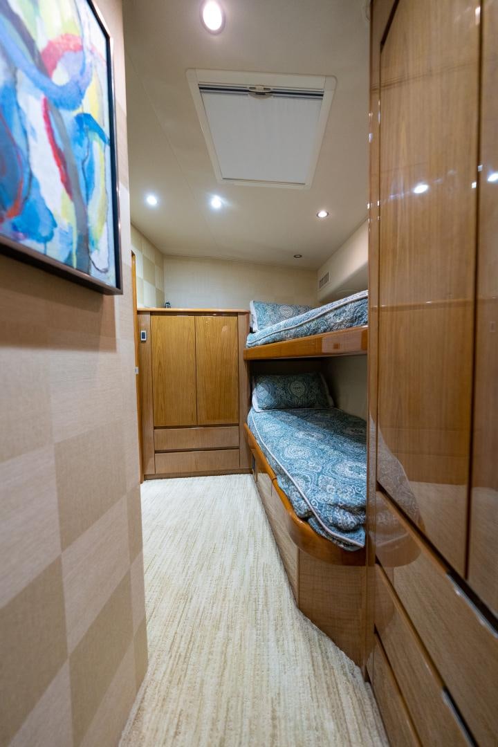 a bedroom with a bed and a closet aboard MM CRICKET Yacht for Sale