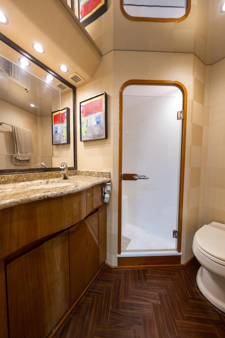 a bathroom with a glass shower door aboard MM CRICKET Yacht for Sale