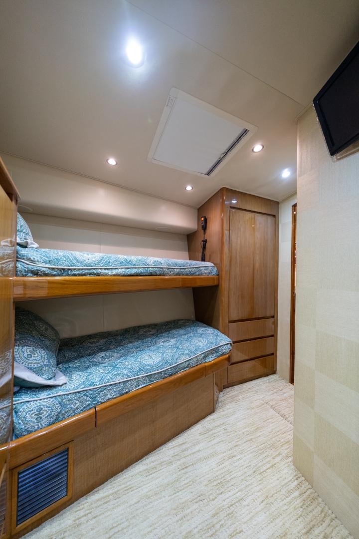 a bedroom with a bed and a wood closet aboard MM CRICKET Yacht for Sale