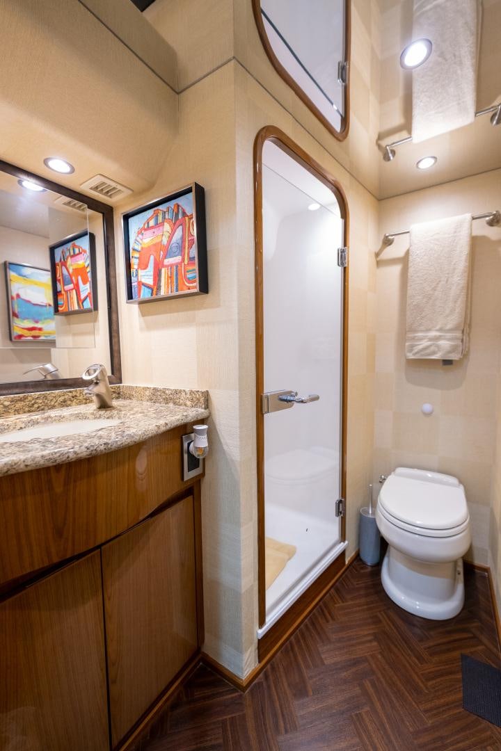 a bathroom with a toilet and a sink aboard MM CRICKET Yacht for Sale