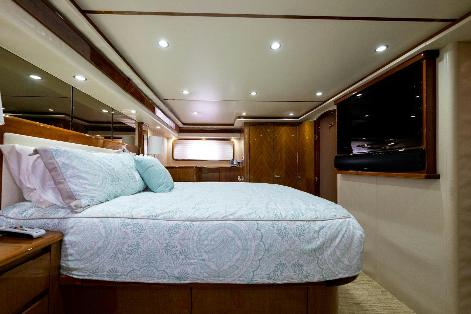 a bed with a white comforter aboard MM CRICKET Yacht for Sale