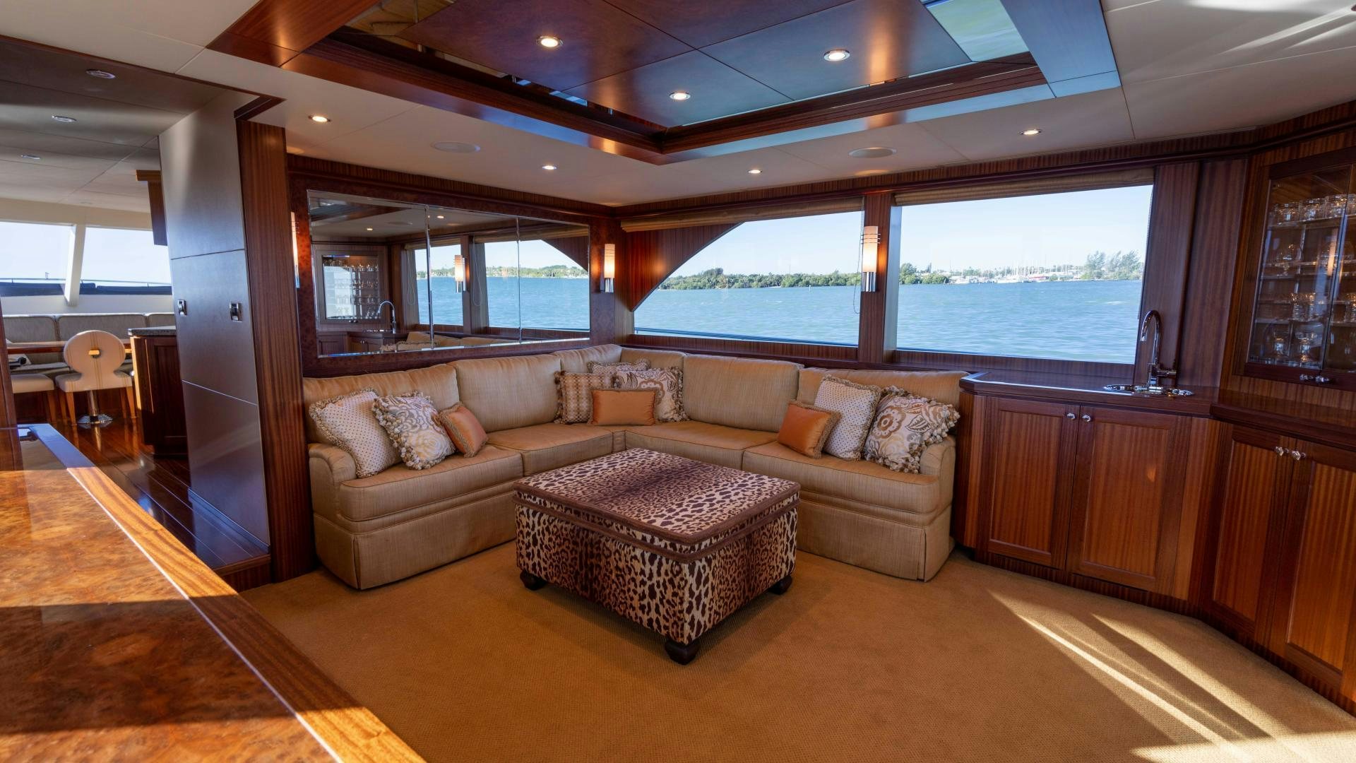 a living room with a couch and a large window aboard RHYTHM'N BLUES Yacht for Sale