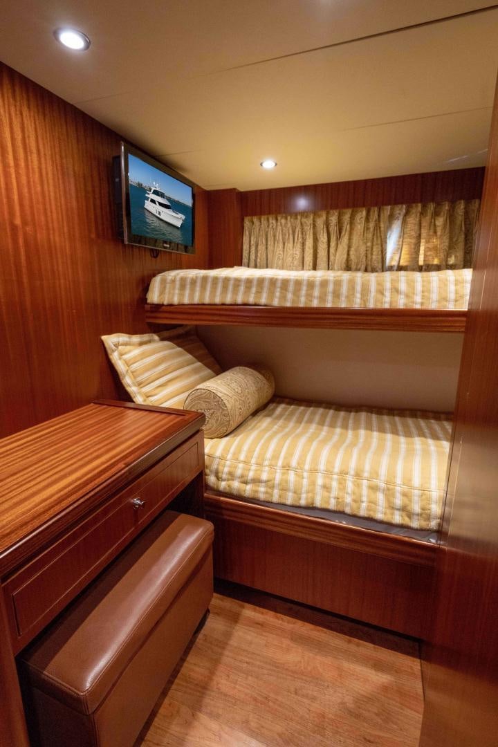 a bedroom with a bed and a tv aboard RHYTHM'N BLUES Yacht for Sale
