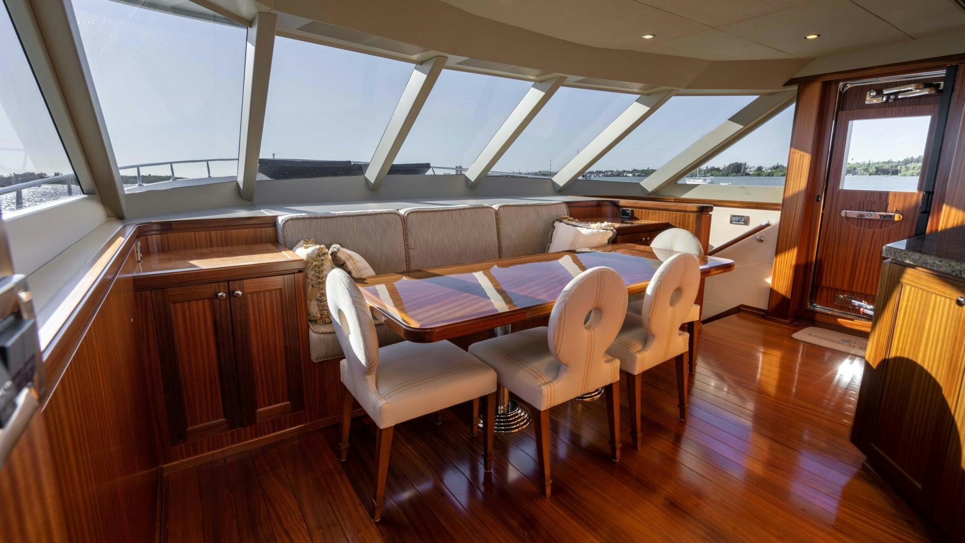 a dining room with wood floors aboard RHYTHM'N BLUES Yacht for Sale