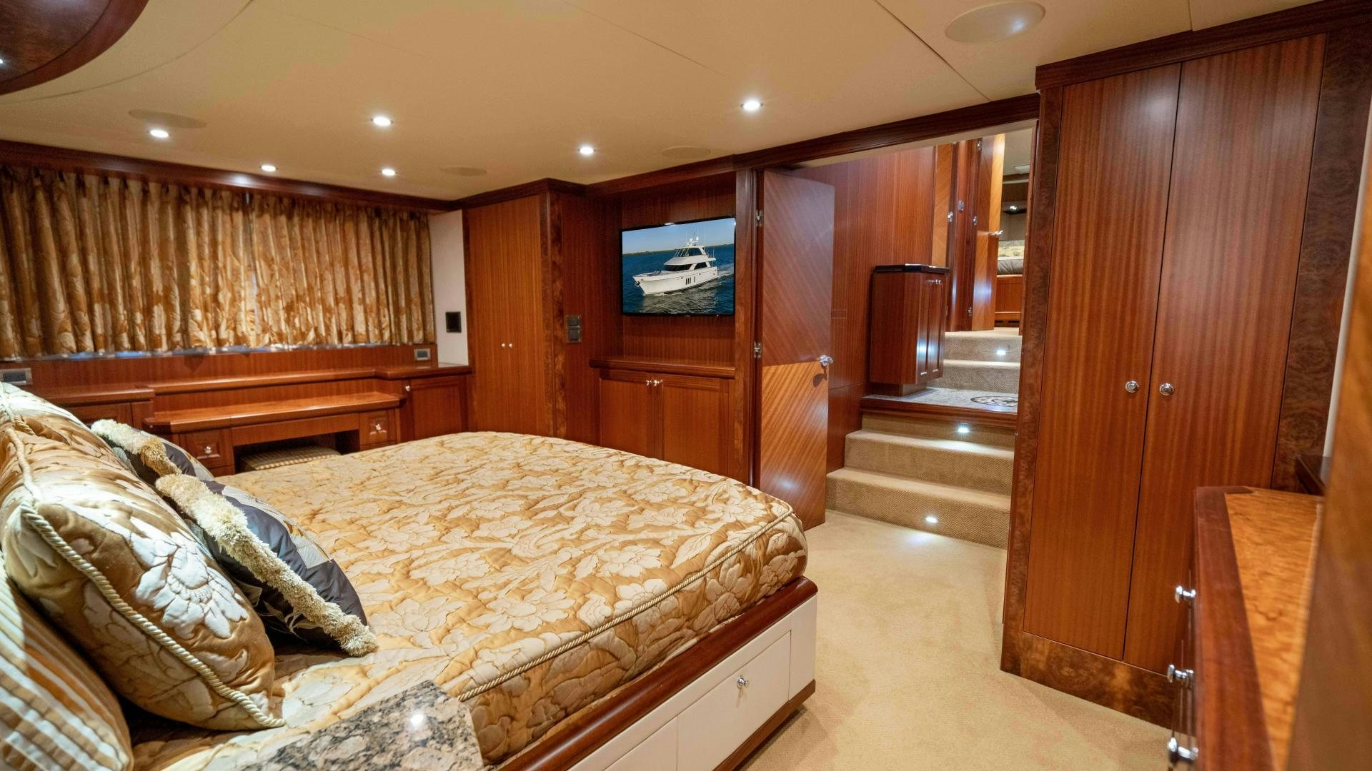 a bedroom with wood cabinets aboard RHYTHM'N BLUES Yacht for Sale
