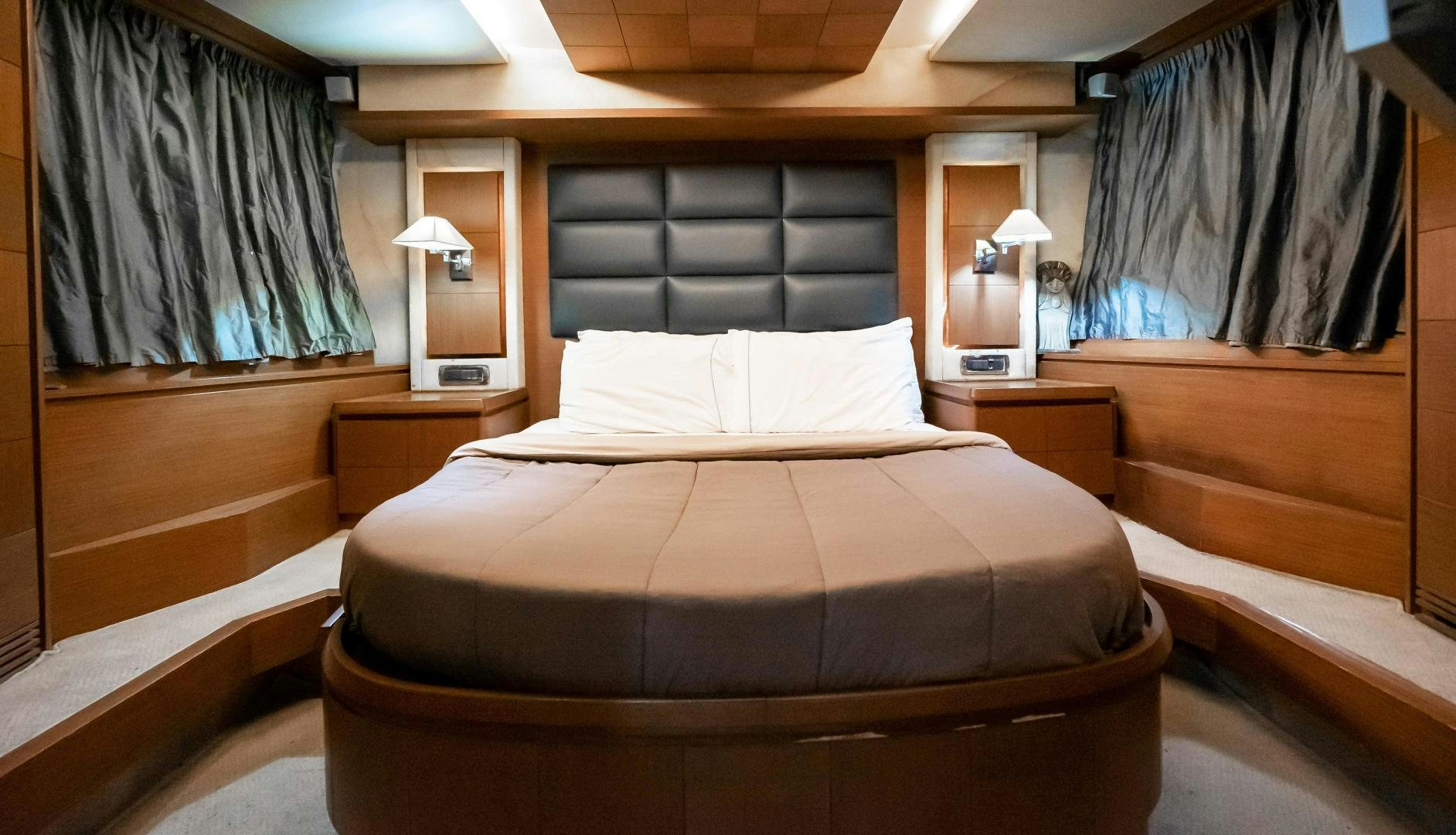 a bed with a black and white comforter and pillows aboard CAMY ED Yacht for Sale