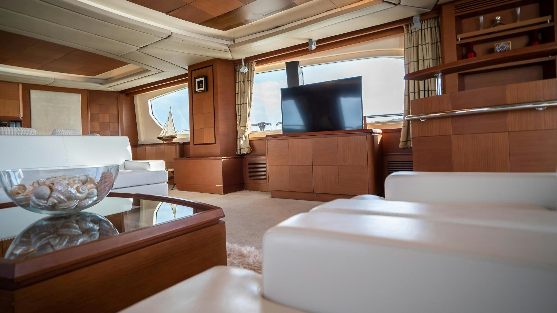 a room with a television and a table aboard CAMY ED Yacht for Sale