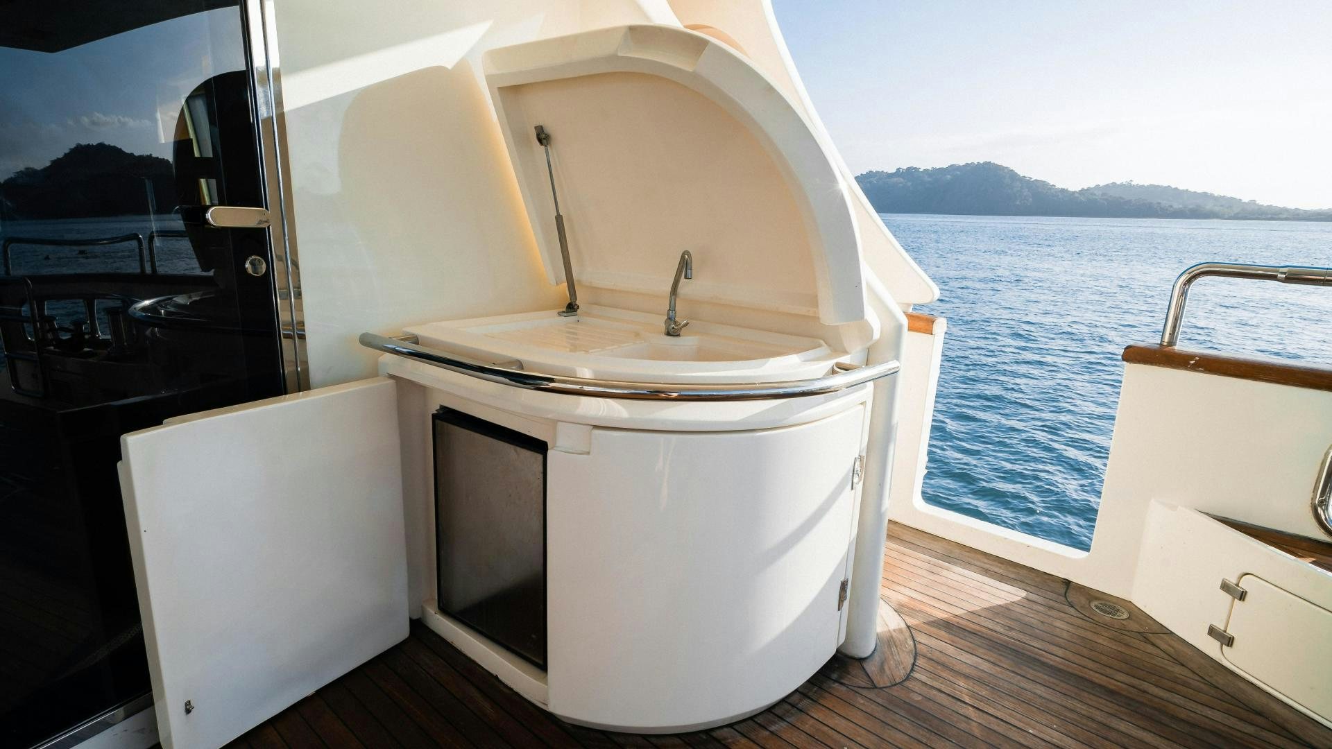 a white kitchen with a large white refrigerator aboard CAMY ED Yacht for Sale
