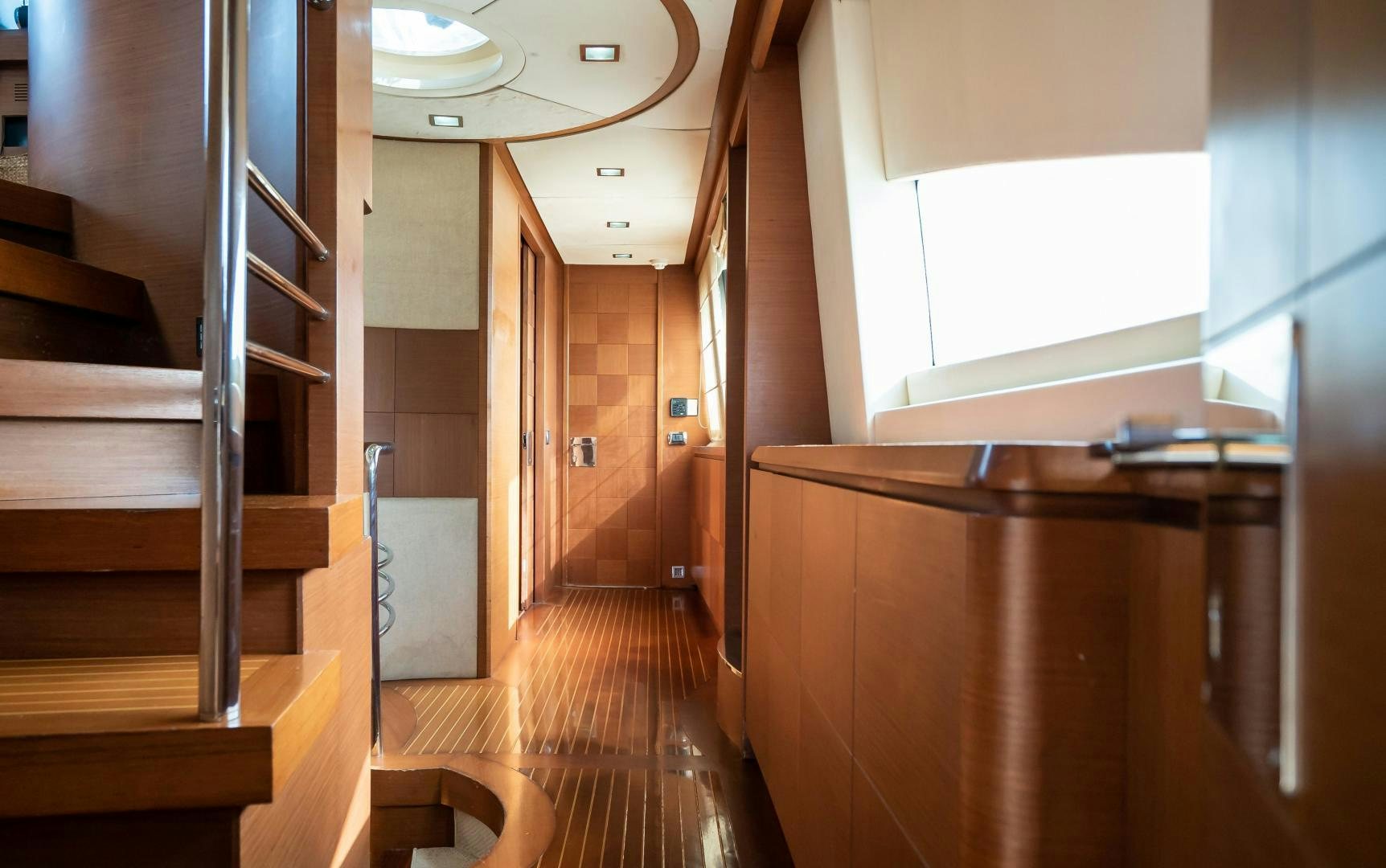 a room with wooden stairs aboard CAMY ED Yacht for Sale