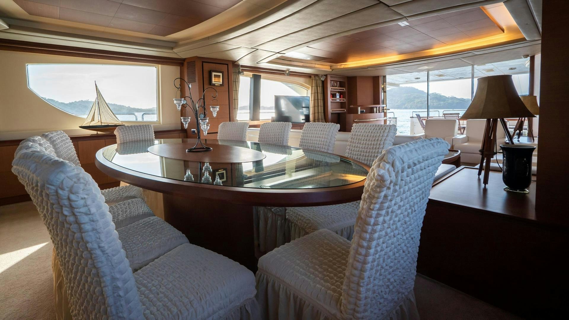 a living room with a table and chairs aboard CAMY ED Yacht for Sale
