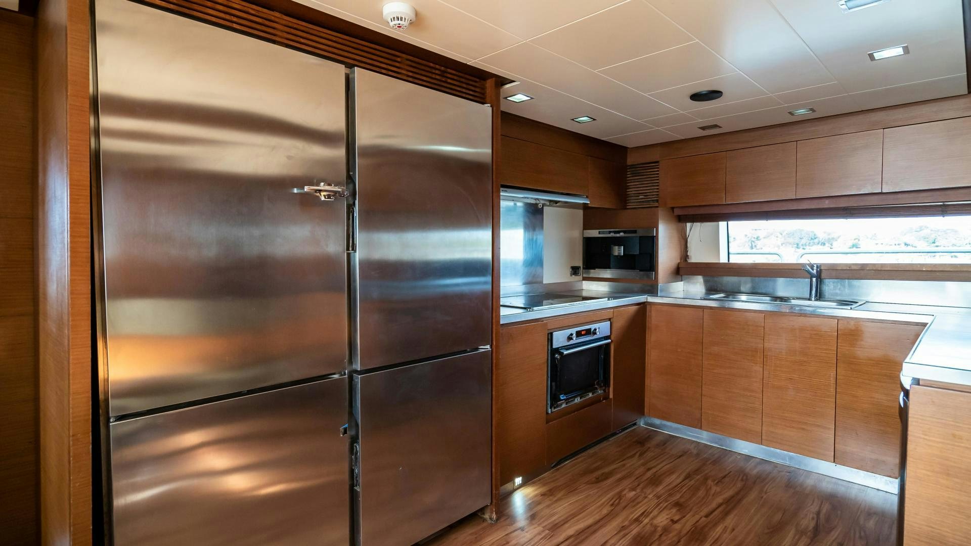 a large kitchen with wooden cabinets aboard CAMY ED Yacht for Sale