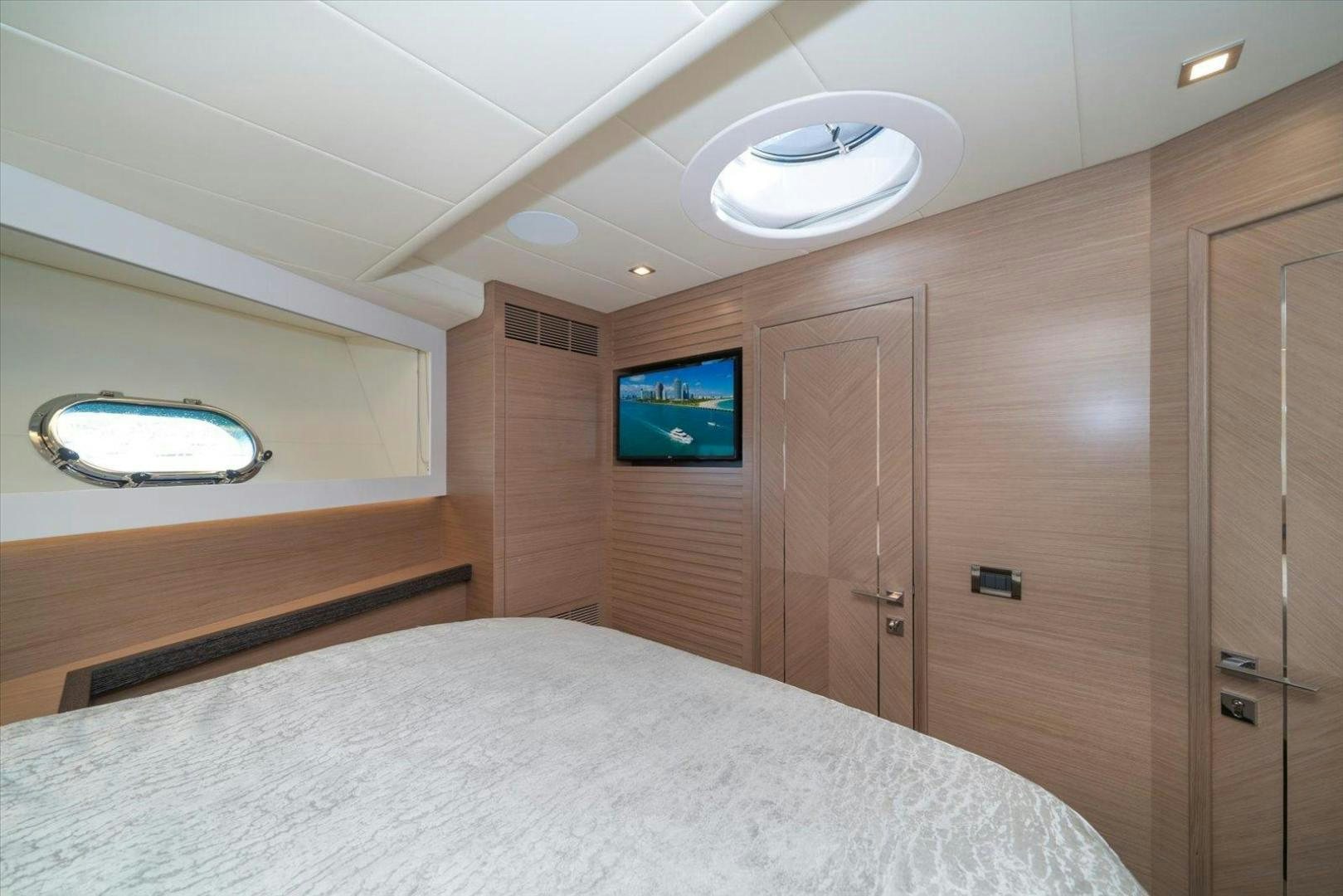 a room with a bed and a television aboard VALIANT Yacht for Sale