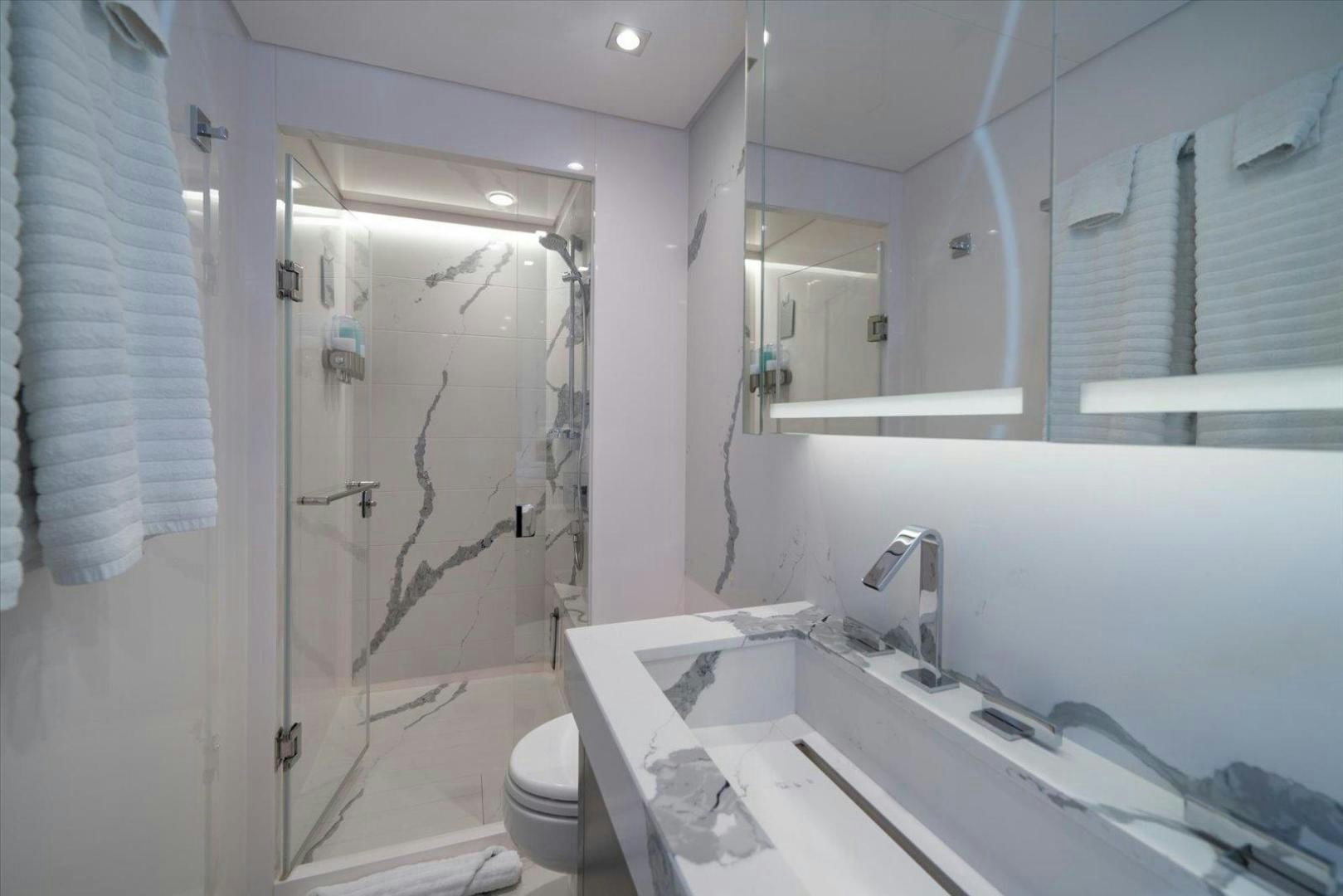 a bathroom with a shower curtain aboard VALIANT Yacht for Sale