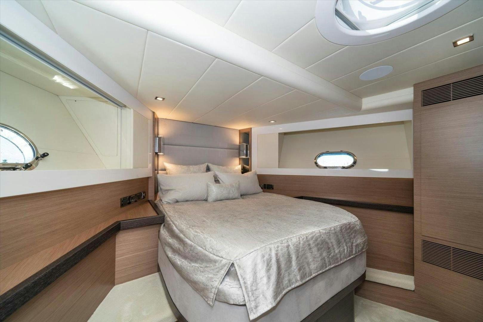 a room with a bed and a mirror aboard VALIANT Yacht for Sale