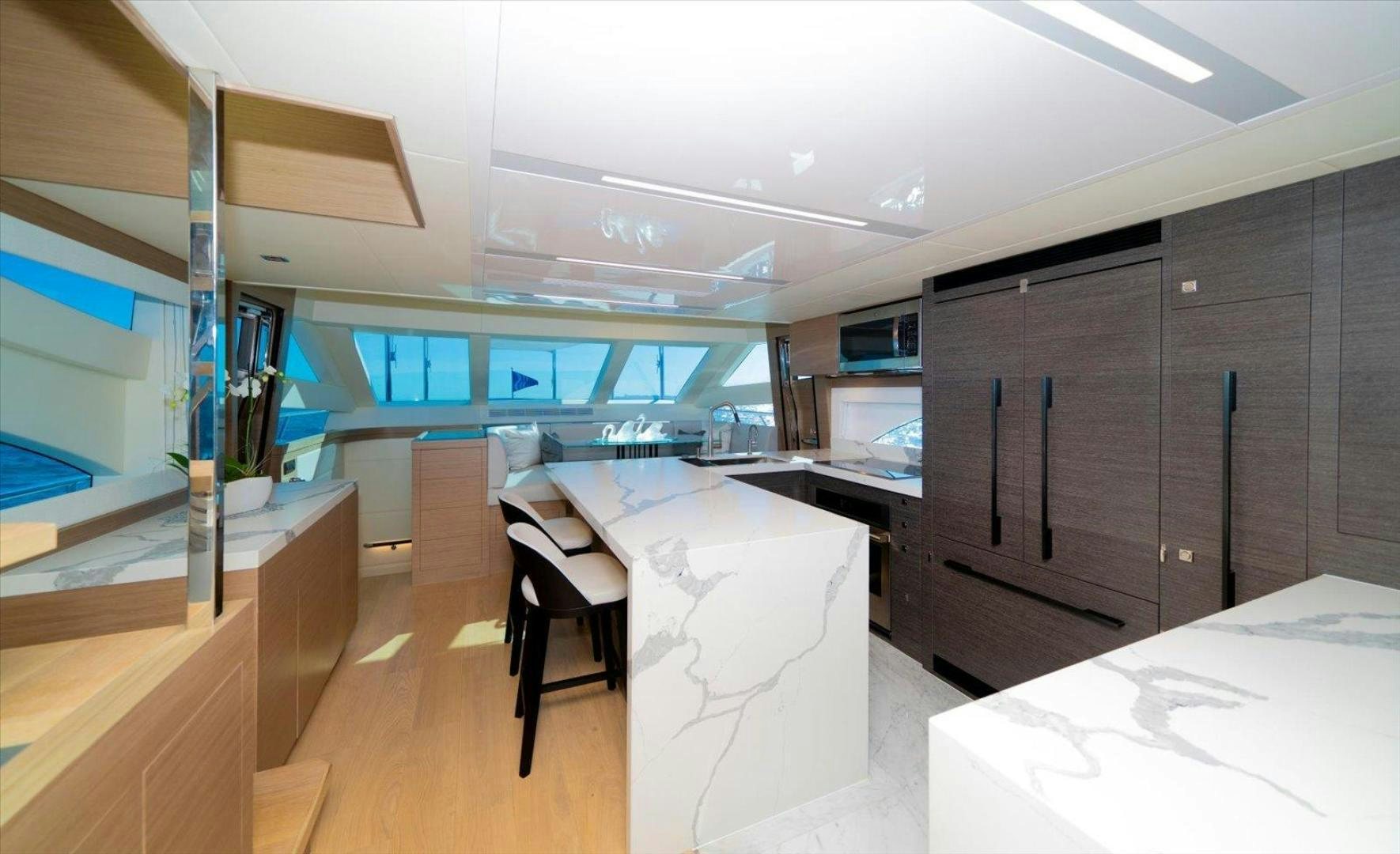 a room with tables and chairs aboard VALIANT Yacht for Sale