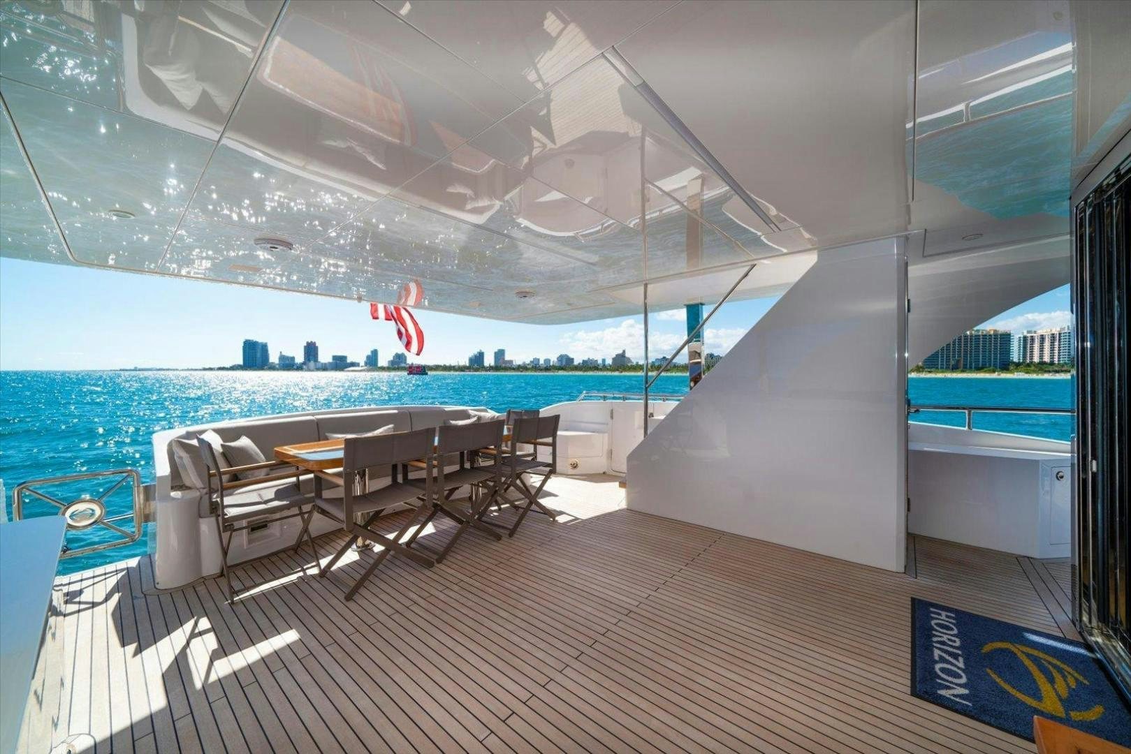 a room with a table chairs and a pool aboard VALIANT Yacht for Sale