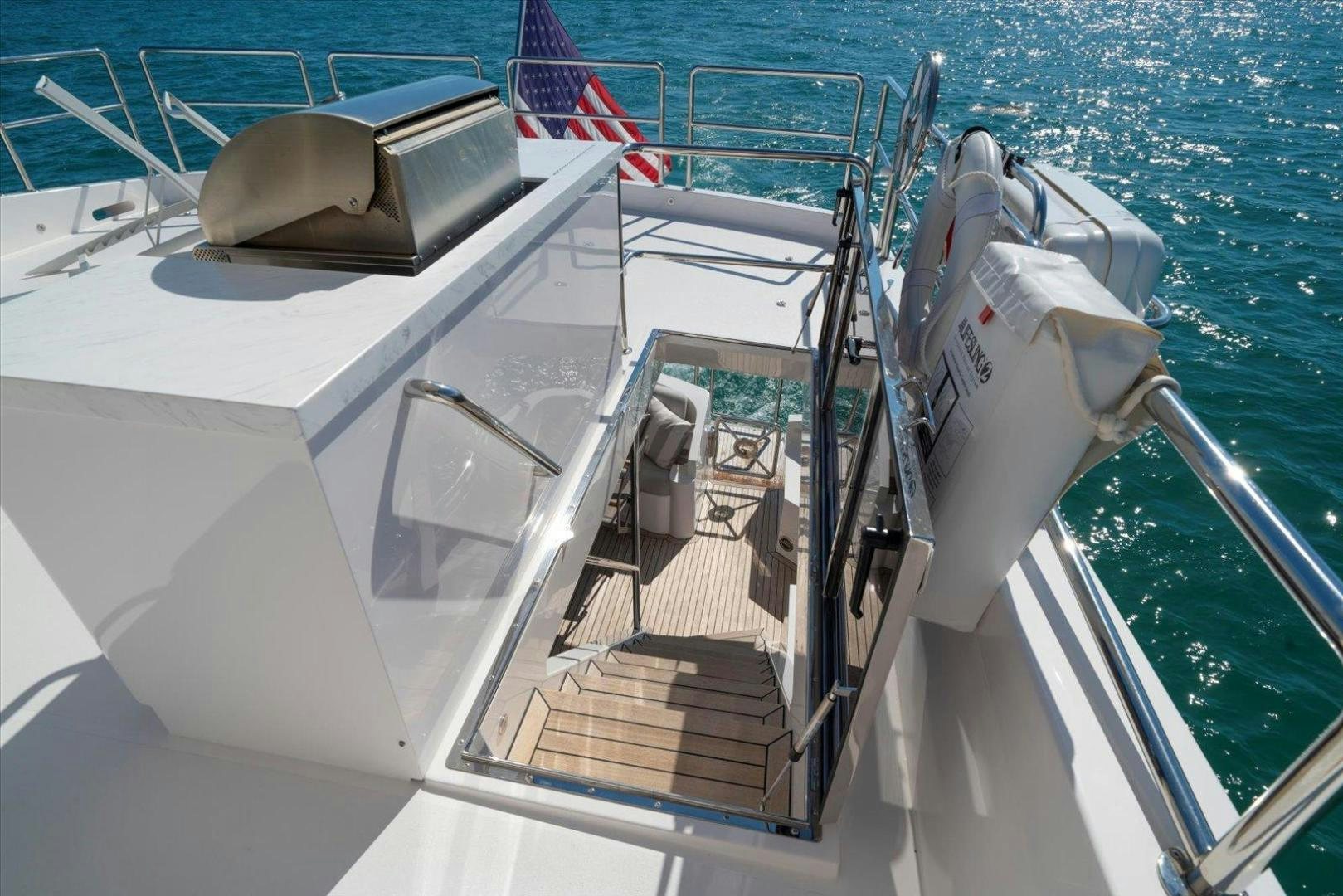a boat with a chair on the deck aboard VALIANT Yacht for Sale