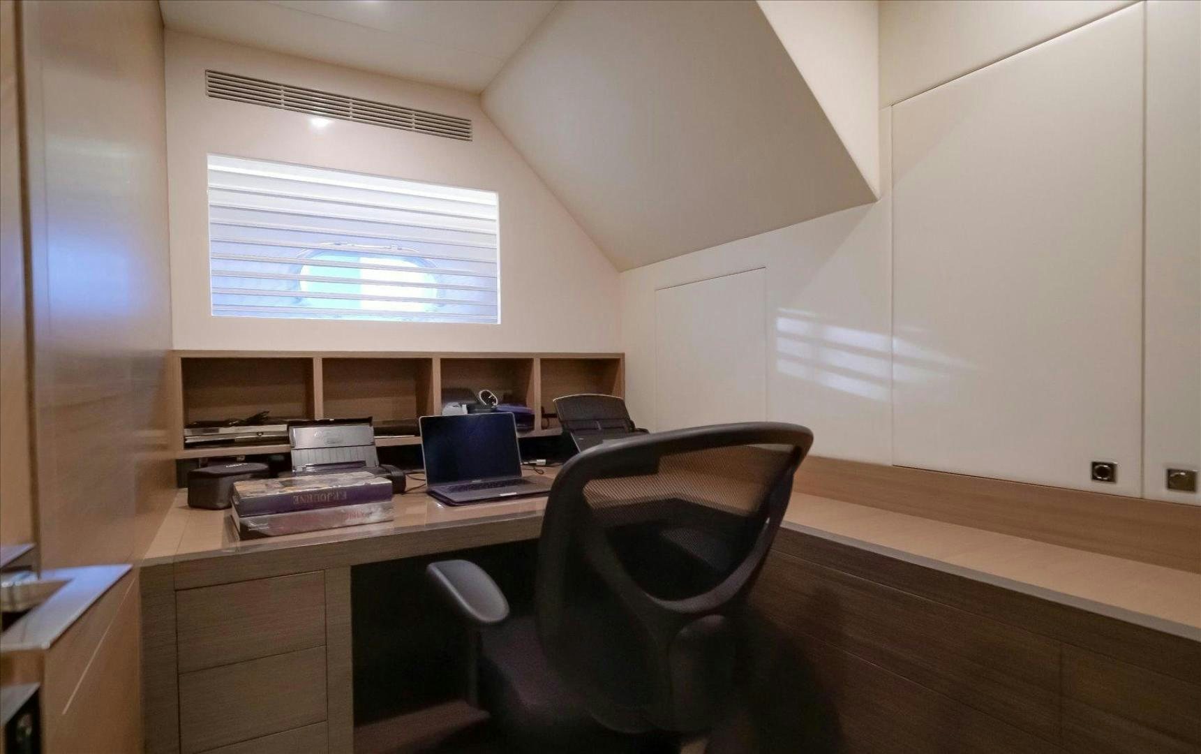 a room with a desk and a laptop aboard VALIANT Yacht for Sale