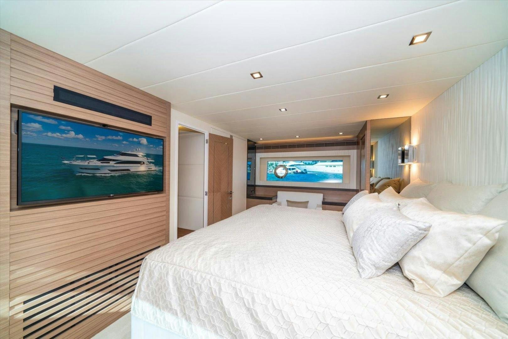a bedroom with a large television aboard VALIANT Yacht for Sale