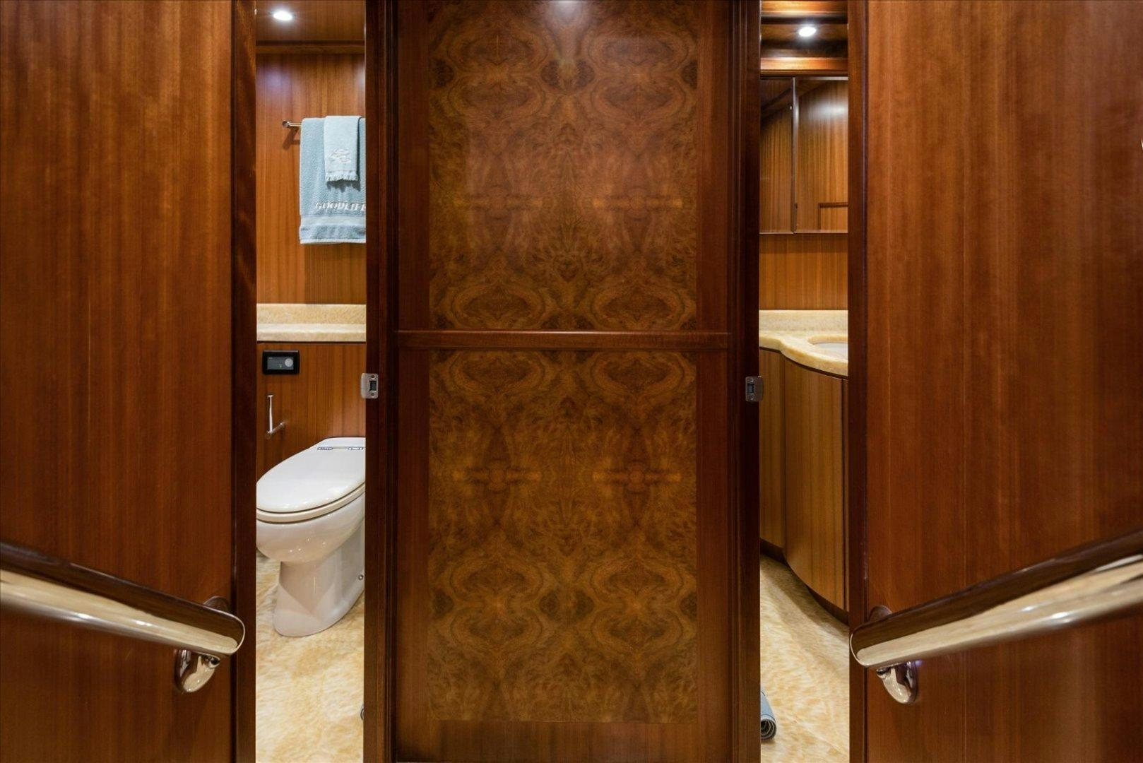 a bathroom with a wood door aboard Goodlife Yacht for Sale
