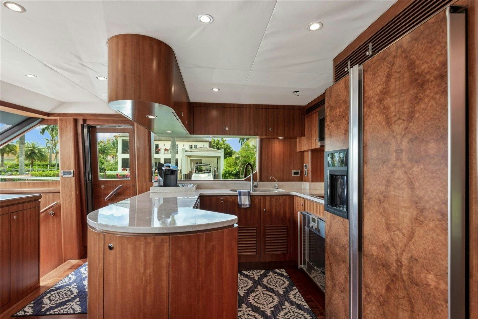 a kitchen with wooden cabinets aboard Goodlife Yacht for Sale