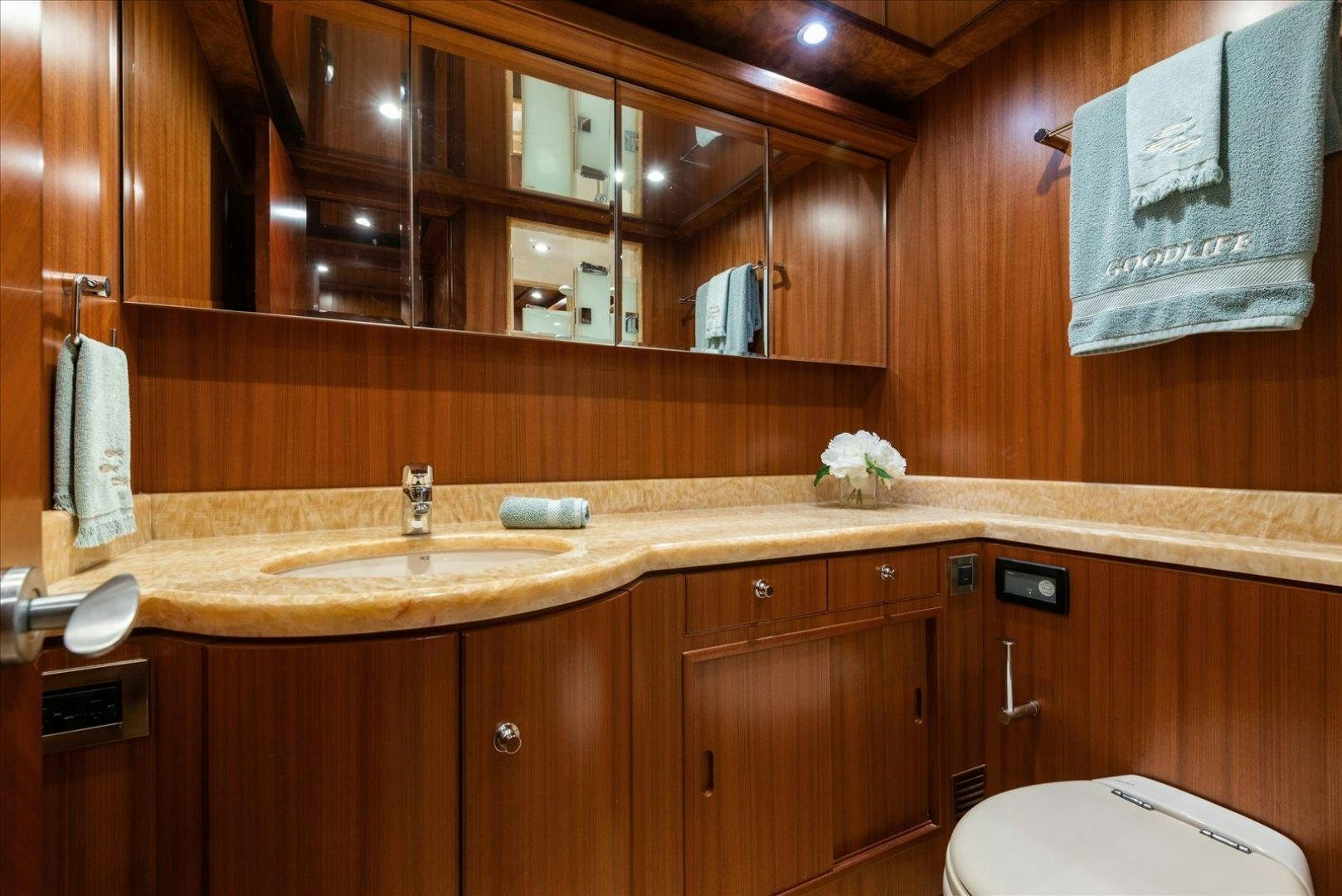a bathroom with wooden cabinets aboard Goodlife Yacht for Sale