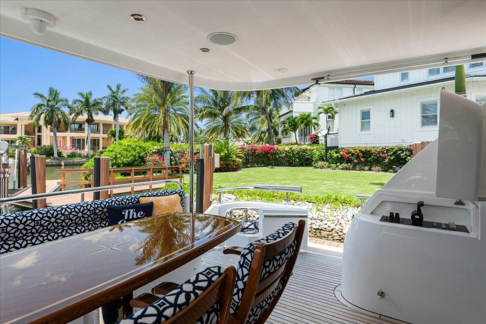 a balcony with a pool and a deck with chairs and trees aboard Goodlife Yacht for Sale