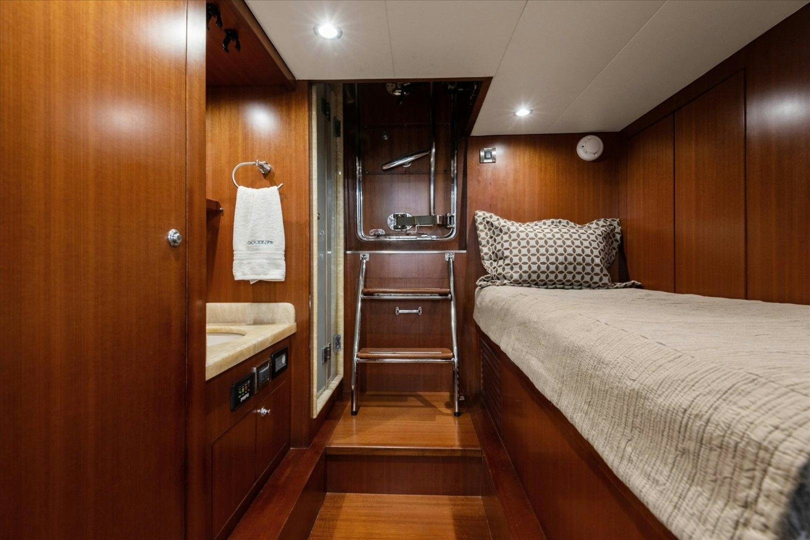 a bedroom with a bed and a closet aboard Goodlife Yacht for Sale