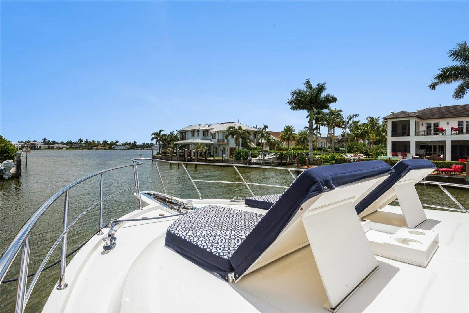 a pool with a deck and a building in the background aboard Goodlife Yacht for Sale