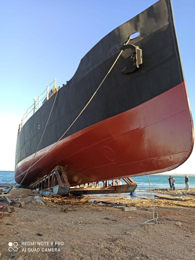 a boat on the beach aboard USS WILLIAMSBURG Yacht for Sale